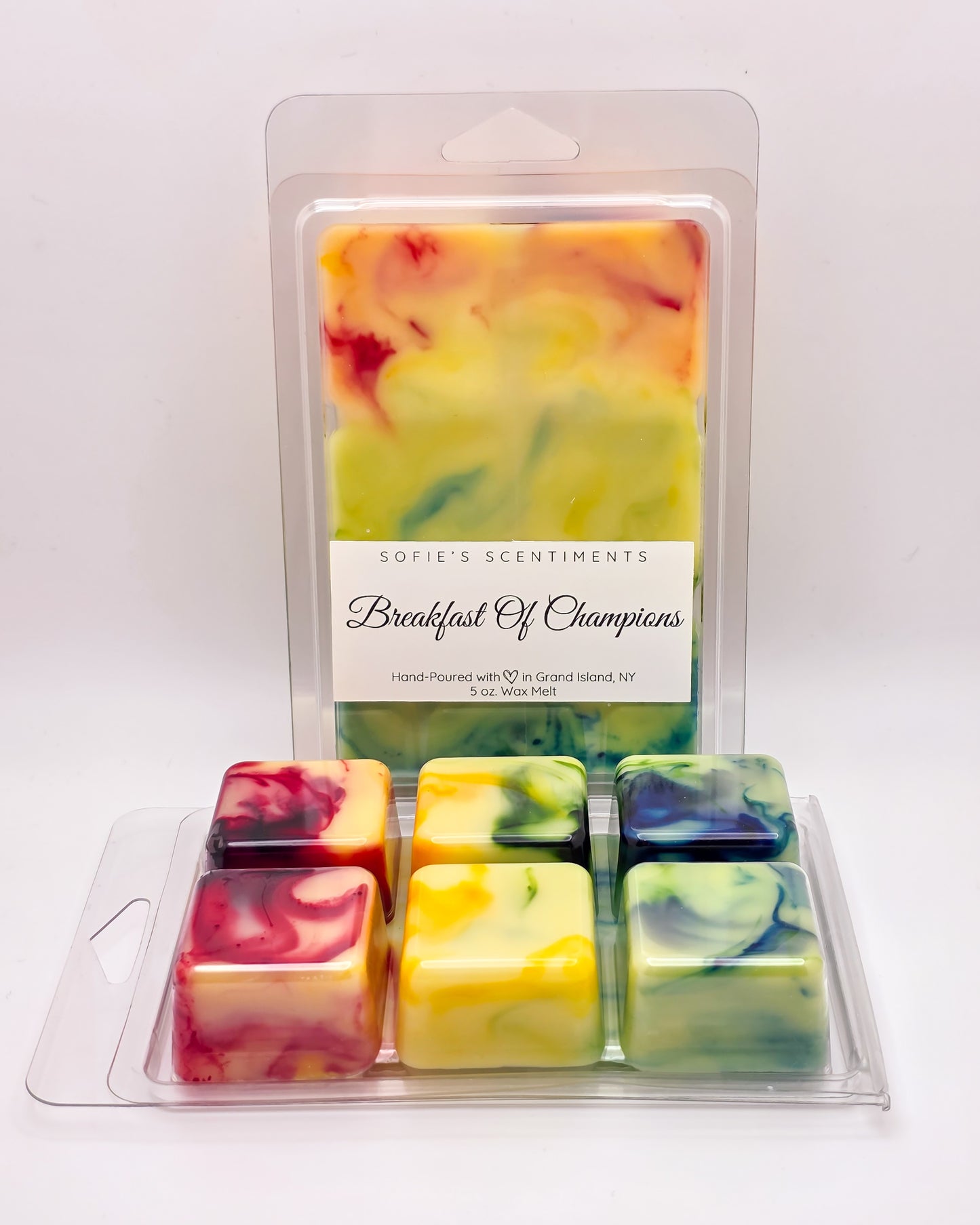 Front and back view of Breakfast of Champions Wax Melt โ marbled yellow, white, and rainbow wax, showcasing the sweet blend of lemon, lime, grapefruit, vanilla, and sandalwood.
